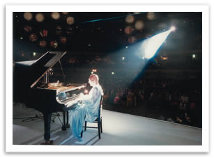 Sri Chinmoy in concert playing the piano.